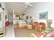 Bright living room with wicker furniture and a view into the dining area at 5211 Mahogany Run Ave # 124, Sarasota, FL 34241