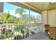 Relaxing screened balcony with patio furniture and scenic view at 5211 Mahogany Run Ave # 124, Sarasota, FL 34241