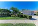 Home exterior with lush landscaping and paver driveway at 5224 88Th E St, Bradenton, FL 34211