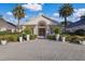 Grand clubhouse entrance with paved pathway and lush landscaping at 5224 88Th E St, Bradenton, FL 34211