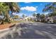 Elegant clubhouse entrance with palm trees and a golf cart at 5224 88Th E St, Bradenton, FL 34211