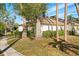 Exterior view of a light-colored house with mature trees and landscaping at 5348 Royal Palm Ave # 5348, Sarasota, FL 34234