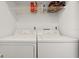 Laundry room includes washer and dryer with overhead shelving at 5348 Royal Palm Ave # 5348, Sarasota, FL 34234