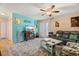 Living room with teal walls, comfy seating, and a large TV at 5348 Royal Palm Ave # 5348, Sarasota, FL 34234