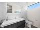 Modern bathroom with marble walls and floating vanity at 5351 Moeller Ave, Sarasota, FL 34233