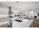 Modern white kitchen with stainless steel appliances and a large island at 5351 Moeller Ave, Sarasota, FL 34233