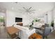 Spacious living room featuring white sofas and a large TV at 5351 Moeller Ave, Sarasota, FL 34233