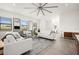 Open concept living room with white sofas and a ceiling fan at 5351 Moeller Ave, Sarasota, FL 34233