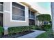 Condo building exterior showing stairs and landscaping at 5360 Hyland Hills Ave # 2622, Sarasota, FL 34241