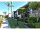 Side view of condo building with walkway and tropical landscaping at 5360 Hyland Hills Ave # 2622, Sarasota, FL 34241