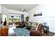 Relaxing living room featuring leather armchairs and a view to balcony at 5360 Hyland Hills Ave # 2622, Sarasota, FL 34241