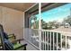 Screened balcony overlooking lush greenery and neighborhood at 5360 Hyland Hills Ave # 2622, Sarasota, FL 34241