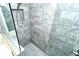 Large walk-in shower with gray tile and glass enclosure at 5360 Hyland Hills Ave # 2622, Sarasota, FL 34241