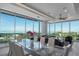 Bright dining area with glass table and stunning water views at 540 N Tamiami Trl # 802, Sarasota, FL 34236