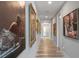 Long hallway adorned with framed artwork and light wood floors at 540 N Tamiami Trl # 802, Sarasota, FL 34236