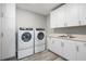 Bright laundry room with side-by-side washer and dryer at 540 N Tamiami Trl # 802, Sarasota, FL 34236