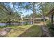 Landscaped backyard with water views and mature trees at 5655 Pipers Waite # 27, Sarasota, FL 34235