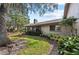 Home's backyard with lush landscaping and patio at 5655 Pipers Waite # 27, Sarasota, FL 34235