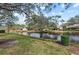 Peaceful backyard oasis with water views and lush landscaping at 5655 Pipers Waite # 27, Sarasota, FL 34235