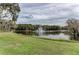 Serene pond with a water fountain, lush landscaping at 5655 Pipers Waite # 27, Sarasota, FL 34235