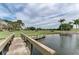 Wooden footbridge over a pond with golf course views at 5655 Pipers Waite # 27, Sarasota, FL 34235