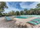 Relaxing pool area with lounge chairs and landscaping at 5655 Pipers Waite # 27, Sarasota, FL 34235