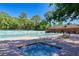 Community pool and spa with surrounding patio at 5655 Pipers Waite # 27, Sarasota, FL 34235