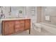 Clean bathroom with wood vanity, marble countertop, and shower/tub combo at 567 Venice Ln, Sarasota, FL 34242