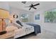 Guest bedroom with king bed, coastal decor, and ceiling fan at 567 Venice Ln, Sarasota, FL 34242