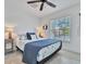 King bed, ceiling fan, and coastal decor in guest bedroom at 567 Venice Ln, Sarasota, FL 34242