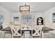 Bright dining room with a farmhouse table and six chairs at 567 Venice Ln, Sarasota, FL 34242