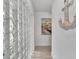 Bright hallway with glass block wall, artwork, and decorative anchor at 567 Venice Ln, Sarasota, FL 34242