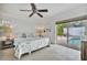 Main bedroom with king-size bed and sliding doors to the pool at 567 Venice Ln, Sarasota, FL 34242