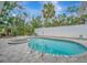 Inviting kidney-shaped pool with a spa and ample patio space at 567 Venice Ln, Sarasota, FL 34242