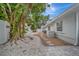 Landscaped side yard with mature tree at 567 Venice Ln, Sarasota, FL 34242