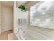 Relaxing bathroom with a garden tub and large window at 5811 100Th E Ave, Parrish, FL 34219