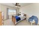 Charming bedroom with a wooden bed frame and a ceiling fan at 5811 100Th E Ave, Parrish, FL 34219