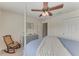 Serene bedroom with a four-poster bed, a ceiling fan, and a rocking chair at 5811 100Th E Ave, Parrish, FL 34219