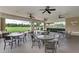 Relaxing outdoor patio with tables and chairs, overlooking green space at 5811 100Th E Ave, Parrish, FL 34219