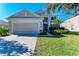 Two-story house with attached garage and landscaping at 5811 100Th E Ave, Parrish, FL 34219