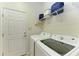 Bright laundry room with washer, dryer, and shelving at 5811 100Th E Ave, Parrish, FL 34219