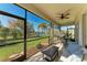 Relaxing screened porch overlooking the backyard and lake at 5811 100Th E Ave, Parrish, FL 34219