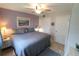 Spacious main bedroom with king-size bed and lavender walls at 5891 Welcome Rd # I6, Bradenton, FL 34207