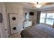 Main bedroom with a king-size bed and built-in washer/dryer at 5891 Welcome Rd # I6, Bradenton, FL 34207