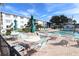 Community pool with lounge chairs and tables at 5891 Welcome Rd # I6, Bradenton, FL 34207