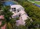 Luxury waterfront home with tile roof, expansive patio, and lush landscaping at 601 Weston Pointe Ct, Longboat Key, FL 34228