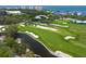 Stunning aerial view of golf course, marina, and bay at 601 Weston Pointe Ct, Longboat Key, FL 34228