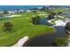 Drone view of lush golf course with water features at 601 Weston Pointe Ct, Longboat Key, FL 34228