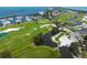 Aerial view of a lush golf course community near the ocean at 601 Weston Pointe Ct, Longboat Key, FL 34228