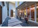 Stone courtyard with potted plants and a walkway leading to the front door at 601 Weston Pointe Ct, Longboat Key, FL 34228